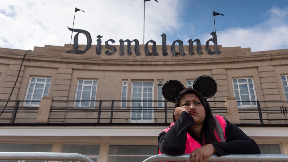 A steward is seen outside Bansky's 'Dismaland' exhibition at a derelict seafront lido on Aug. 20, 2015 in Weston-Super-Mare, England. (Photo by Matthew Horwood/Getty)