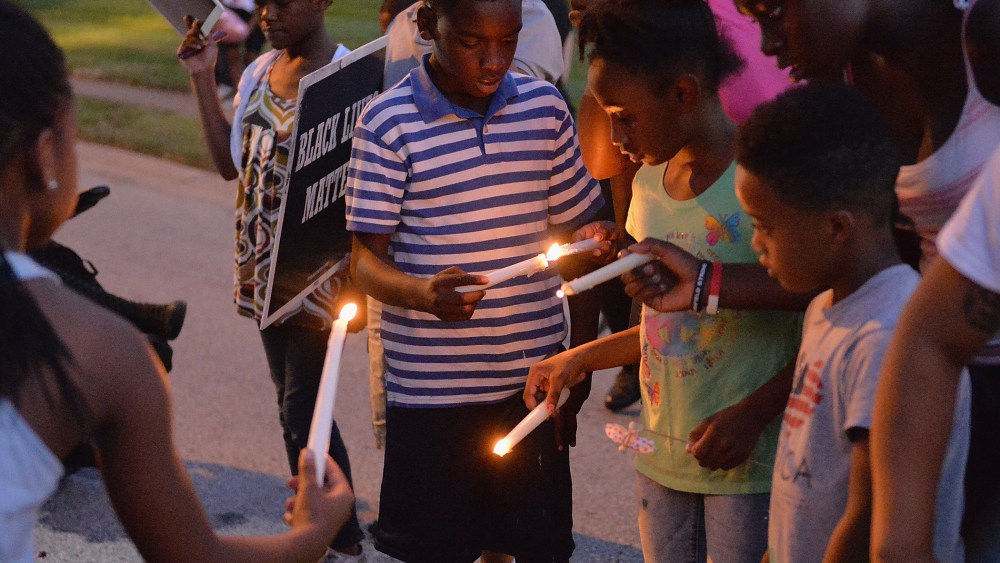 Children gather at the Michael Brown Jr. memorial on Canfield Drive during a candlelight vigil held in honor of Jamyla Bolden on August 20, 2015 in Ferguson, Missouri. (Photo by Michael B. Thomas/Getty)