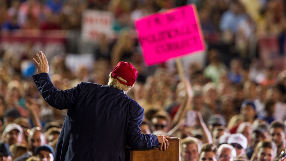 A Donald Trump supporter's sign reads "I'm Not Politically Correct" as the Republican presidential candidate speaks during a rally on August 21, 2015 in Mobile, Alabama. (Photo by Mark Wallheiser/Getty)