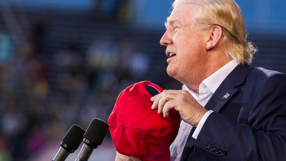 U.S. Republican presidential candidate Donald Trump removes his hat at Ladd-Peebles Stadium on August 21, 2015 in Mobile, Alabama. (Photo by Mark Wallheiser/Getty)