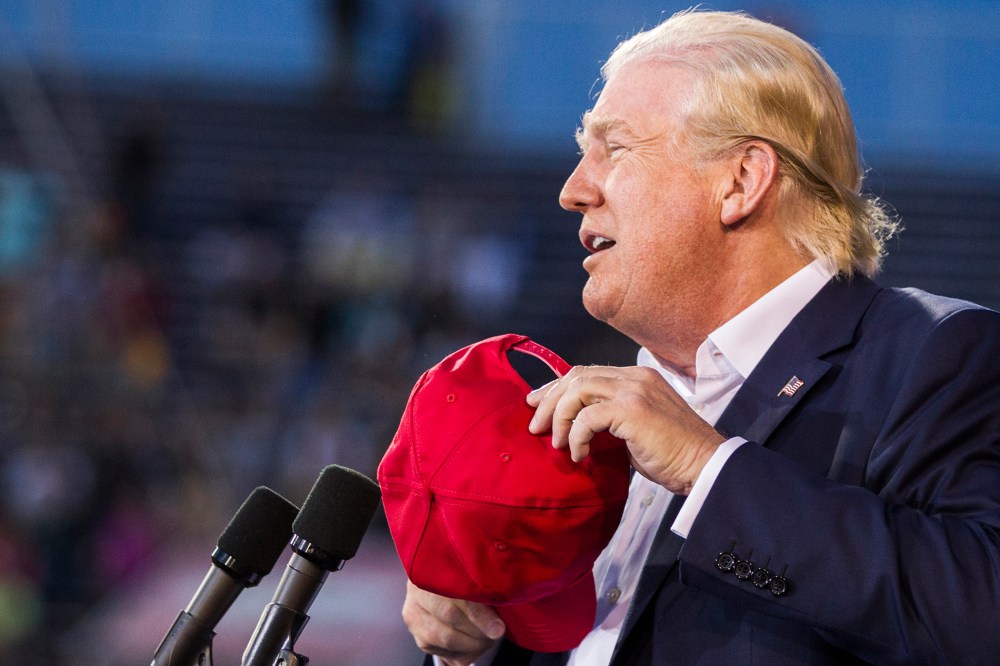 U.S. Republican presidential candidate Donald Trump removes his hat at Ladd-Peebles Stadium on August 21, 2015 in Mobile, Alabama. (Photo by Mark Wallheiser/Getty)