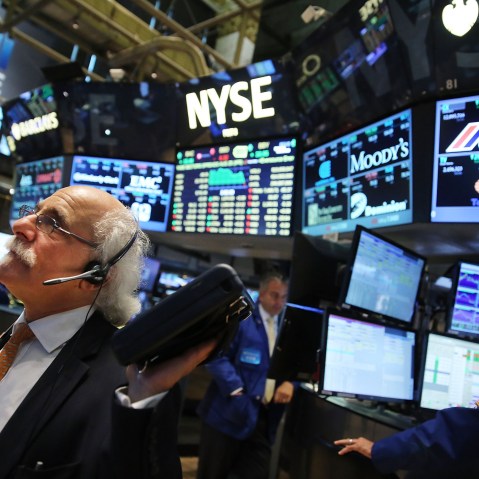 Traders work on the floor of the New York Stock Exchange (NYSE) on Aug. 25, 2015 in New York City. (Photo by Spencer Platt/Getty)