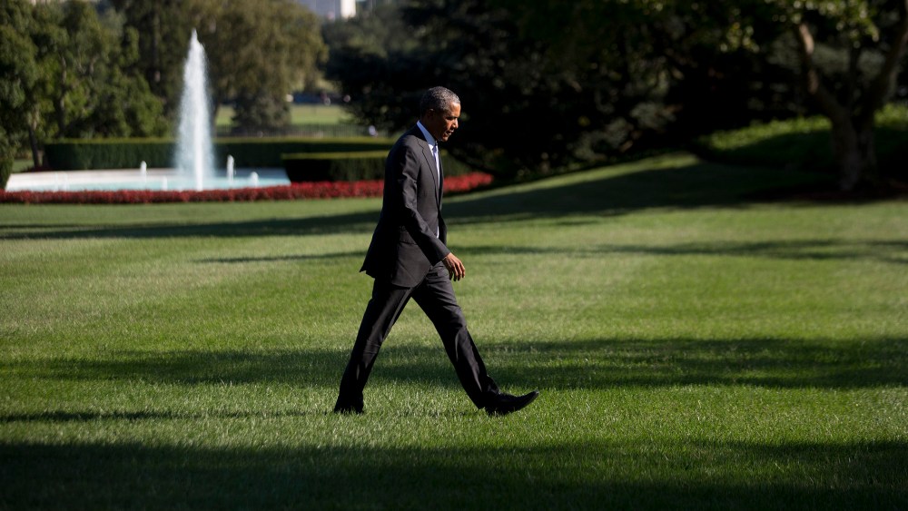 President Barack Obama walks toward the White House after landing on the South Lawn on Aug. 25 in Washington, D.C. (Photo by Andrew Harrer/Pool/Getty)