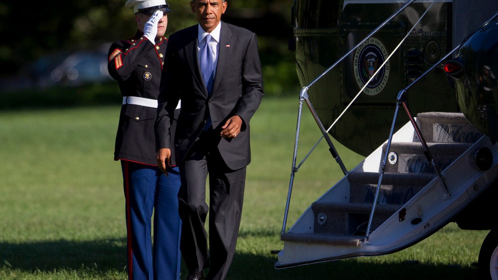 President Barack Obama walks off of Marine One after landing on the South Lawn of the White House on Aug. 25 in Washington, DC. (Photo by Andrew Harrer/Pool/Getty)