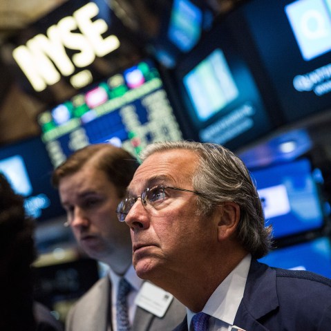 A trader works on the floor of the New York Stock Exchange during the morning of August 27, 2015 in New York City. (Photo by Andrew Burton/Getty)