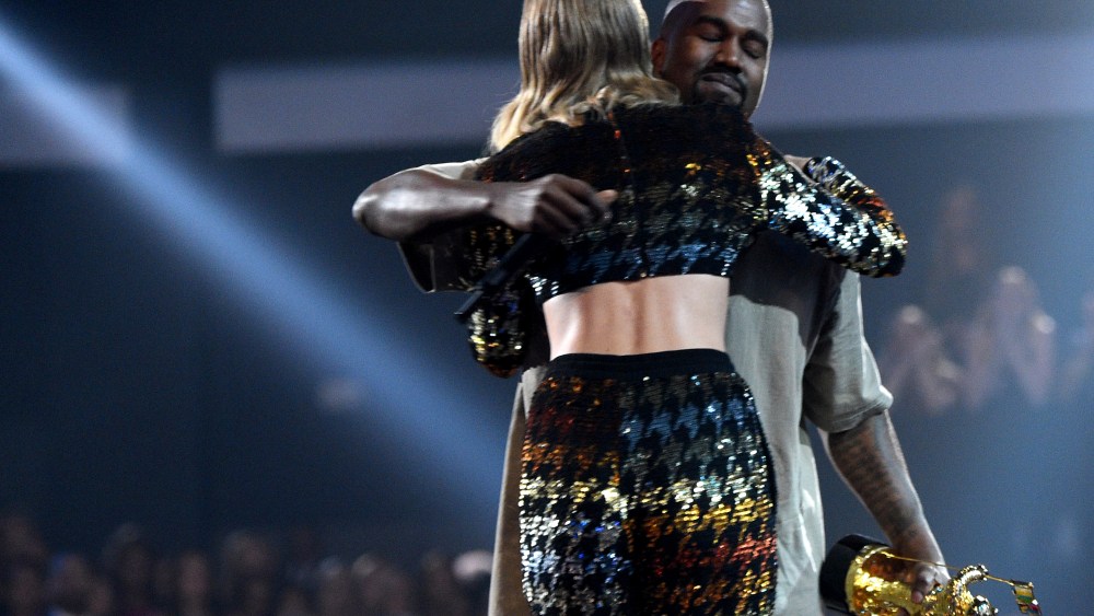 Recording artist Taylor Swift hugs recording artist Kanye West after presenting him with the Vanguard Award onstage during the 2015 MTV Video Music Awards at Microsoft Theater on Aug. 30, 2015 in Los Angeles, Calif. (Photo by Larry Busacca/MTV1415/Getty)