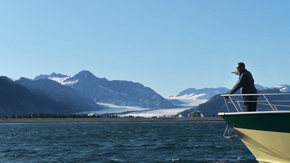 President Barack Obama points to Bear Glacier during a boat tour of the Kenai Fjords National Park on Sept. 1, 2015 in Seward, Alaska. (Photo by Mandel Ngan/AFP/Getty)