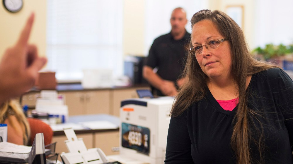 Kim Davis, the Rowan County Clerk of Courts, listens to Robbie Blankenship and Jesse Cruz as they speak with her about getting a marriage license at the County Clerks Office on Sep. 2, 2015 in Morehead, Ky. (Photo by Ty Wright/Getty)