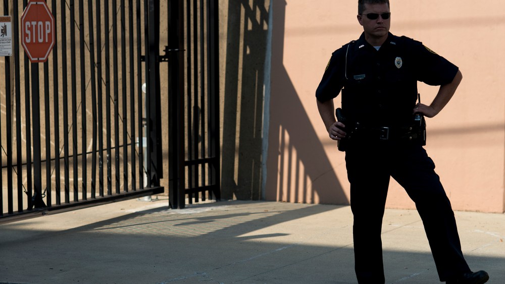 An Ashland police officer stands on guard in the back of the federal courthouse during Rowan County Clerk Kim Davis's hearing on Sep. 3, 2015 in Ashland. (Photo by Ty Wright/Getty)