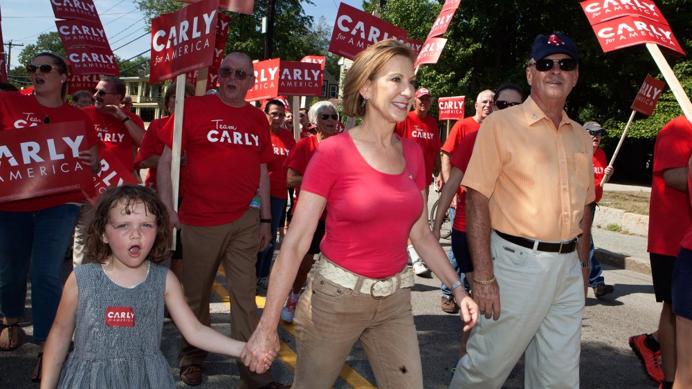 Republican presidential candidate Carly Fiorina, who has been rising in the polls, marches with her family in the Labor Day parade on Sep. 7, 2015 in Milford, N.H. (Photo by Kayana Szymczak/Getty)