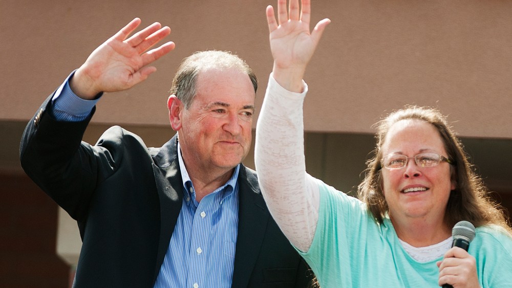 Republican presidential candidate Mike Huckabee (L) stands behind Rowan County Clerk of Courts Kim Davis (R) in front of the Carter County Detention Center on September 8, 2015 in Grayson, Kentucky. (Photo by Ty Wright/Getty)
