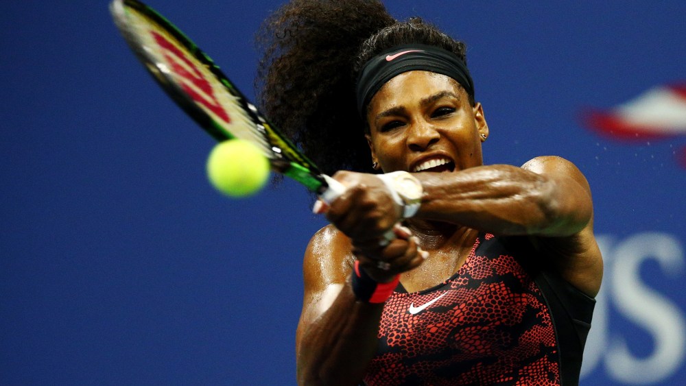 Serena Williams returns a shot to Venus Williams, both of the United States, during their Women's Singles Quarterfinals match on Day Nine of the 2015 US Open on Sept. 8, 2015, New York City. (Photo by Clive Brunskill/Getty)