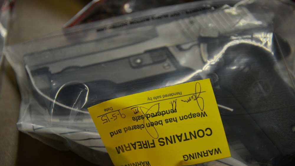 Seized guns are displayed as Mayor Muriel Bowser and Metropolitan Police Department Chief Cathy Lanier speak about the city's illegal guns and gun violence, Sept. 8, 2015, in Washington, DC. (Photo by Jahi Chikwendiu/The Washington Post/Getty)