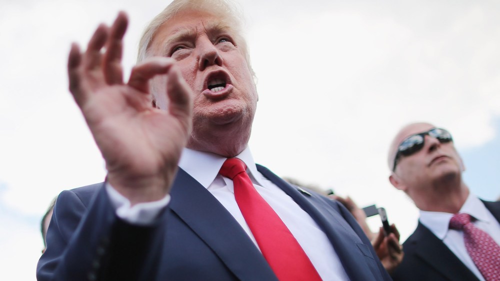 Republican presidential candidate Donald Trump talks with journalists during a rally on the West Lawn of the U.S. Capitol September 9, 2015 in Washington, DC. (Photo by Chip Somodevilla/Getty)