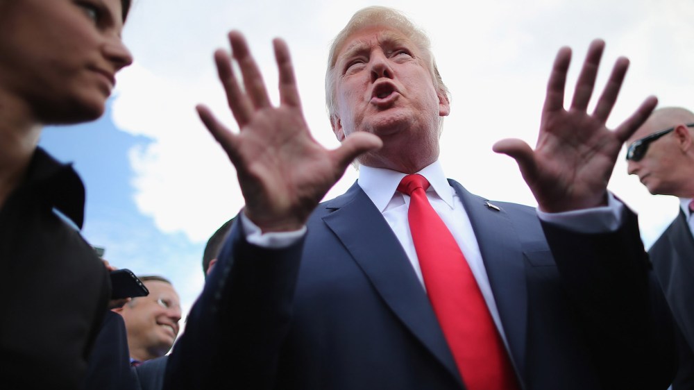 Republican presidential candidate Donald Trump talks with journalists during a rally against the Iran nuclear deal on the West Lawn of the U.S. Capitol on Sept. 9, 2015 in Washington, DC. (Photo by Chip Somodevilla/Getty)