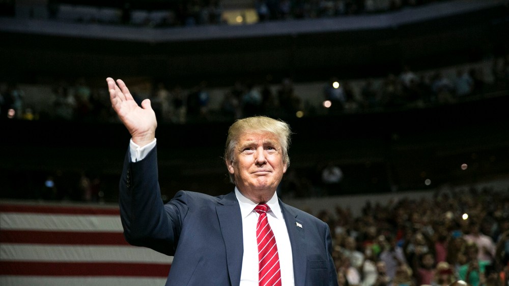 Republican presidential candidate Donald Trump waves during a campaign rally at the American Airlines Center in Dallas, Texas on Sept. 14, 2015. (Photo by Laura Buckman/AFP/Getty)