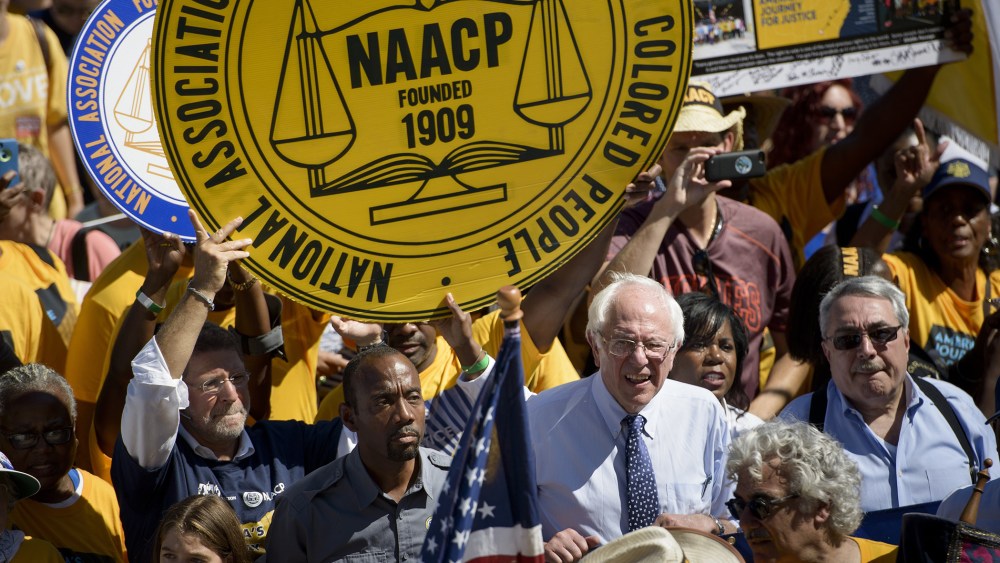 Presidential hopeful Bernie Sanders and Cornell William Brooks, president and CEO of the NAACP walk up the steps of the Lincoln Memorial during the march from Selma, Ala. to Washington, DC Sept. 15, 2015. (Photo by Brendan Smialowski/AFP/Getty)
