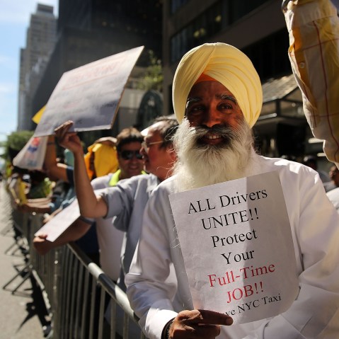 New York City taxi drivers hold a rally in front of Governor Andrew Cuomo's office to protest against recent inroads made by the Uber car service on Sept. 16, 2015 in New York City. (Photo by Spencer Platt/Getty)