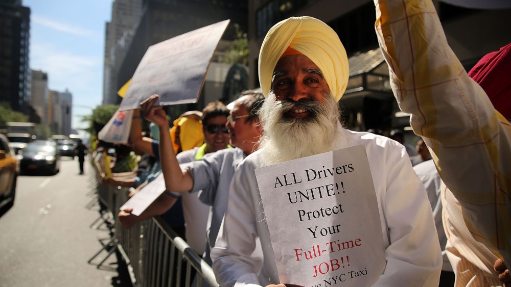 New York City taxi drivers hold a rally in front of Governor Andrew Cuomo's office to protest against recent inroads made by the Uber car service on Sept. 16, 2015 in New York City. (Photo by Spencer Platt/Getty)