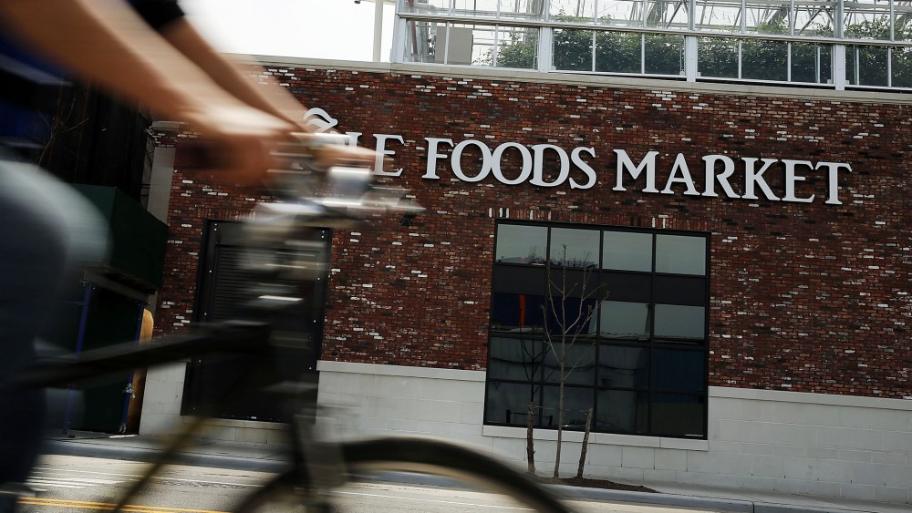 A person bikes past a Whole Foods Market in the Brooklyn borough on May 7, 2014 in New York City. (Photo by Spencer Platt/Getty)