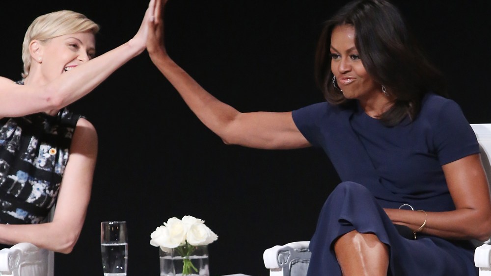 First Lady Michelle Obama receives a high five from actress Charlize Theron during the "Let Girls Learn" Global Conversation at The Apollo Theater on Sept. 29, 2015 in New York City. (Photo by Bennett Raglin/WireImage/Getty)
