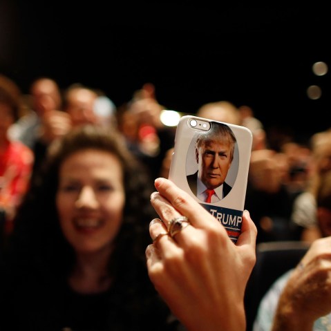 A supporter of Republican presidential candidate Donald Trump takes video on her Trump-branded phone during a campaign rally at the Treasure Island Hotel & Casino on Oct. 8, 2015 in Las Vegas, Nev. (Photo by Isaac Brekken/Getty)