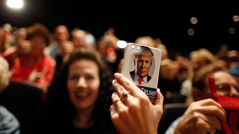 A supporter of Republican presidential candidate Donald Trump takes video on her Trump-branded phone during a campaign rally at the Treasure Island Hotel & Casino on Oct. 8, 2015 in Las Vegas, Nev. (Photo by Isaac Brekken/Getty)