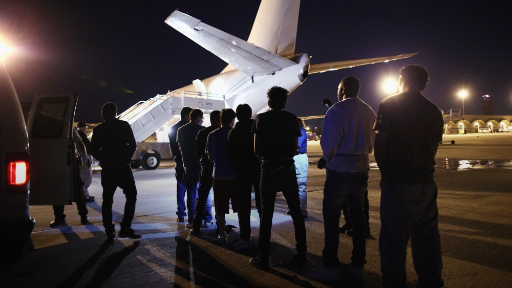 Undocumented immigrants wait to be loaded onto an Immigration and Customs Enforcement (ICE) charter jet early on Oct. 15, 2015 in Mesa, Ariz. (Photo by John Moore/Getty)