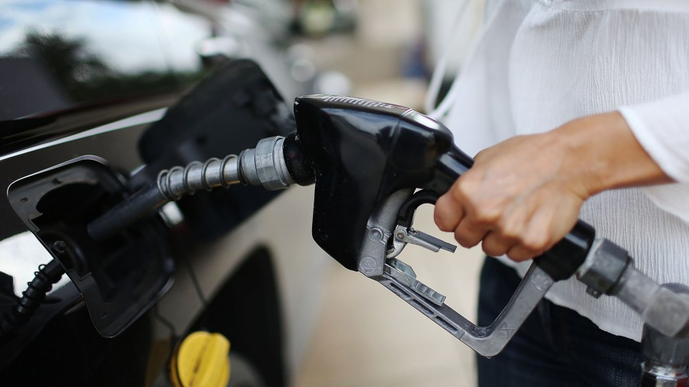 Angela Prada fills her vehicle with gas at a U-Gas station on Oct. 19, 2015 in Miami, Fla. (Photo by Joe Raedle/Getty)