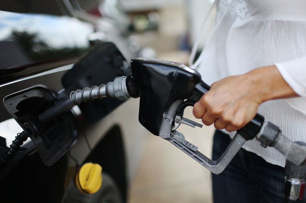 Angela Prada fills her vehicle with gas at a U-Gas station on Oct. 19, 2015 in Miami, Fla. (Photo by Joe Raedle/Getty)