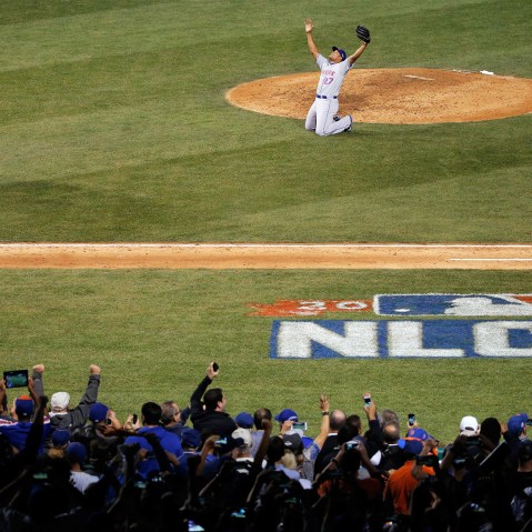 Jeurys Familia #27 and Travis d'Arnaud #7 of the New York Mets celebrate after defeating the Chicago Cubs in game four of the 2015 MLB National League Championship Series at Wrigley Field on Oct. 21, 2015 in Chicago, Ill. (Photo by Jon Durr/Getty)