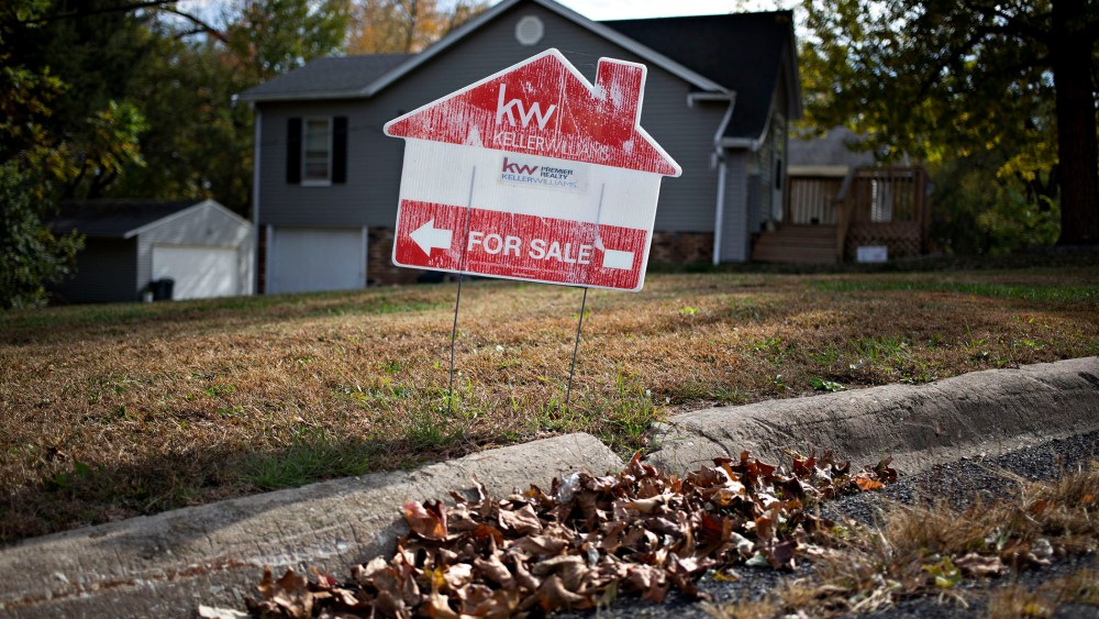 A "For Sale" sign stands outside a home in Peoria, Ill., Oct. 20, 2015. (Photo by Daniel Acker/Bloomberg/Getty)