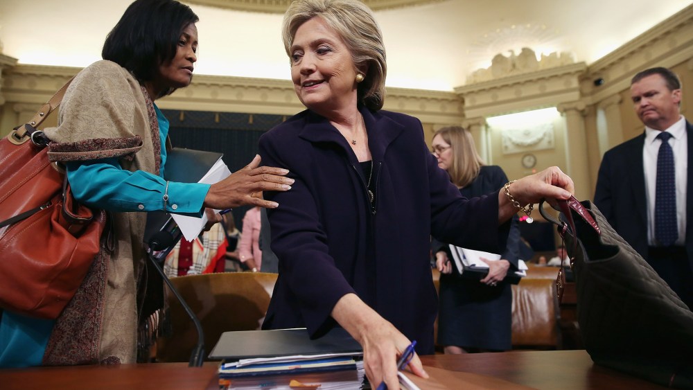 Hillary Clinton and Former State Department Chief of Staff Cheryl Mills take a break in a hearing of the House Select Committee on Benghazi Oct. 22, 2015 on Capitol Hill in Washington, DC. (Photo by Chip Somodevilla/Getty)