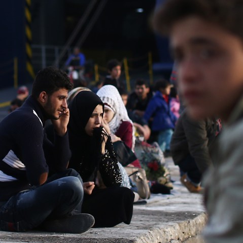 Migrants wait to board a ferry to Athens in Mytilene port on Nov. 10, 2015 in Lesbos, Greece. (Photo by Carl Court/Getty)