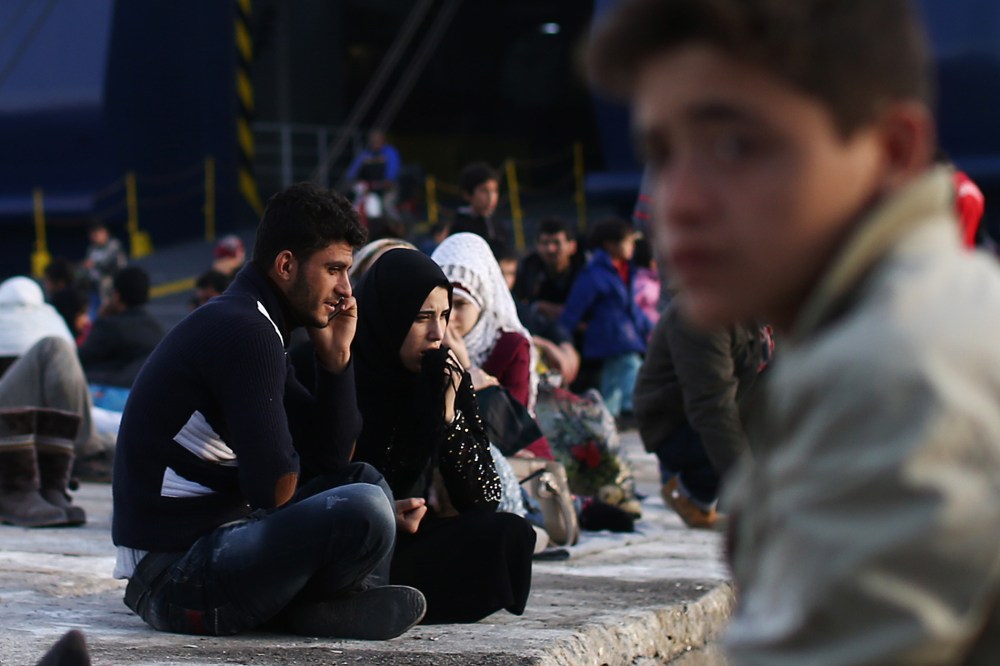 Migrants wait to board a ferry to Athens in Mytilene port on Nov. 10, 2015 in Lesbos, Greece. (Photo by Carl Court/Getty)