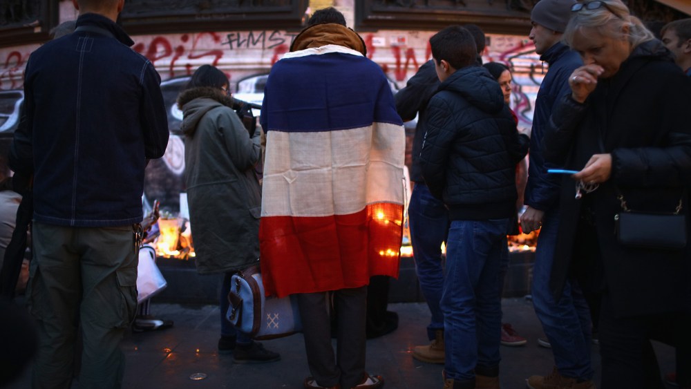 Parisians light candles and lay tributes on the monument at Place de la Republique, the day after deadly terrorist attacks on Nov. 14, 2015 in Paris, France. (Photo by Christopher Furlong/Getty)