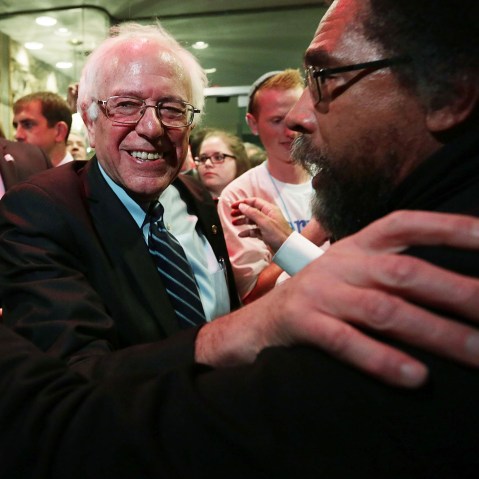 Democratic presidential candidate Sen. Bernie Sanders (I-VT) and philosopher Cornel West (R) embrace at a watch party for the second Democratic presidential debate Nov. 14, 2015 in Des Moines, Iowa. (Photo by Alex Wong/Getty)