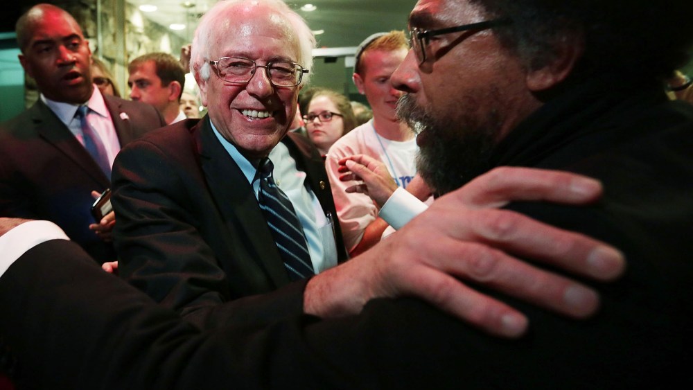 Democratic presidential candidate Sen. Bernie Sanders (I-VT) and philosopher Cornel West (R) embrace at a watch party for the second Democratic presidential debate Nov. 14, 2015 in Des Moines, Iowa. (Photo by Alex Wong/Getty)