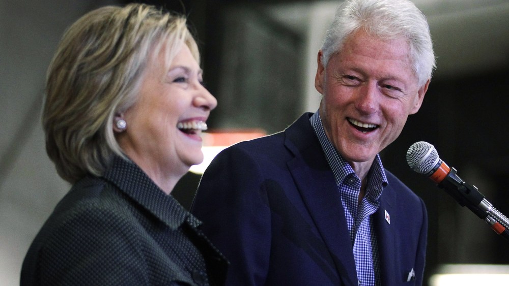 Former President Bill Clinton shares a laugh with his wife and Democratic presidential candidate Hillary Clinton during an event, Nov. 15, 2015 in Ames, Iowa. (Photo by Alex Wong/Getty)