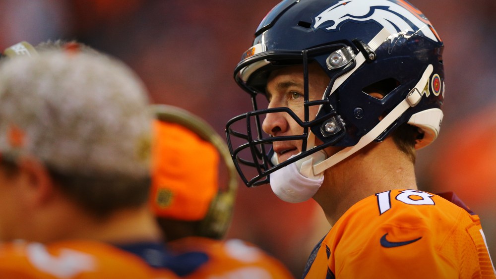 Quarterback Peyton Manning #18 of the Denver Broncos looks on from the bench at Sports Authority Field Field at Mile High on Nov. 15, 2015 in Denver, Colo. (Photo by Justin Edmonds/Getty)