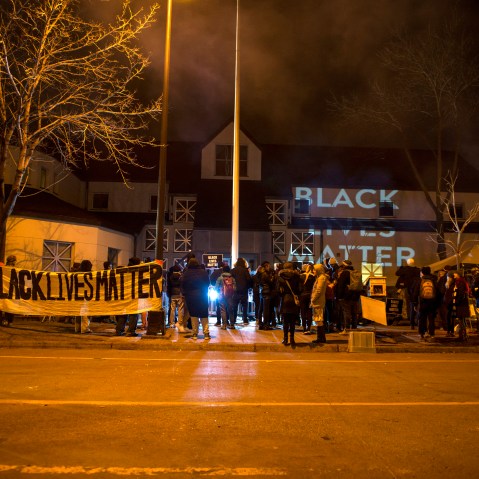Black Lives Matter organizers project slides reading "BLACK LIVES MATTER" on the walls outside the 4th Precinct police station on Nov. 20, 2015 in Minneapolis, Minn. (Photo by Stephen Maturen/Getty)