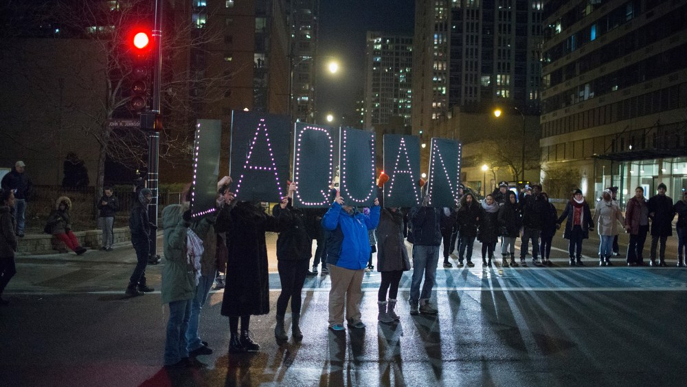 Demonstrators march through downtown following the release of a video showing Chicago Police officer Jason Van Dyke shooting and killing Laquan McDonald on Nov. 24, 2015 in Chicago, Ill. (Photo by Scott Olson/Getty)