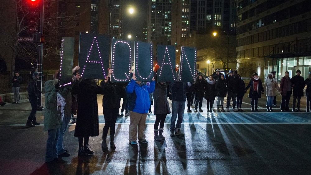 Demonstrators march through downtown following the release of a video showing Chicago Police officer Jason Van Dyke shooting and killing Laquan McDonald on Nov. 24, 2015 in Chicago, Ill. (Photo by Scott Olson/Getty)