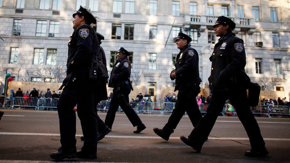 Members of the New York City Police department walk on Central Park West before the annual Thanksgiving Day Parade on Nov. 26, 2015 in New York City. (Photo by Kena Betancur/Getty)