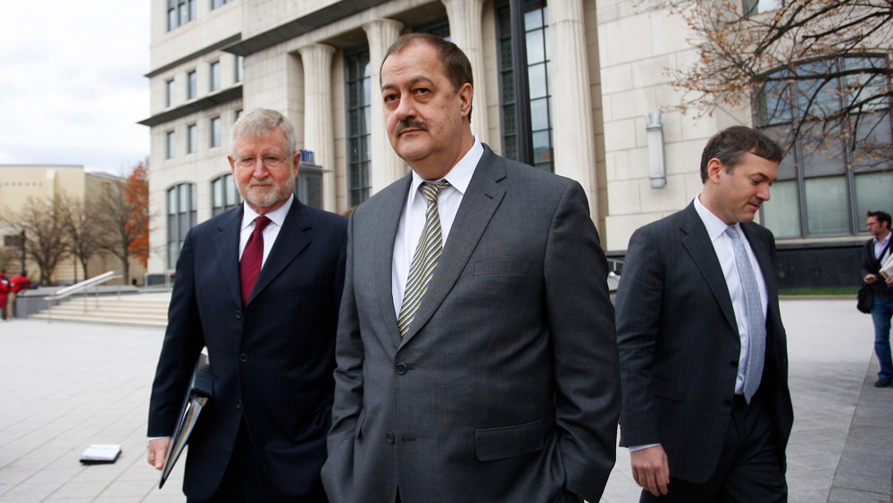 Donald "Don" Blankenship, former chief executive officer of Massey Energy Co., center, and his attorney, left, exit the Robert C. Byrd U.S. Courthouse in Charleston, W. Va., on Dec. 3, 2015. (Photo by Calvin Mattheis/Bloomberg/Getty)