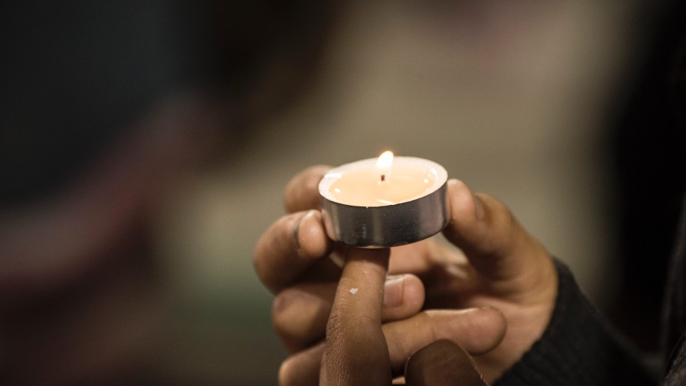 People attend a candlelight vigil at the San Manuel Stadium in San Bernardino, Calif., Dec. 3, 2015 for victims of the Dec. 2 mass shooting in San Bernardino which left 14 dead and at least 17 injured. (Photo by Robyn Beck/AFP/Getty)