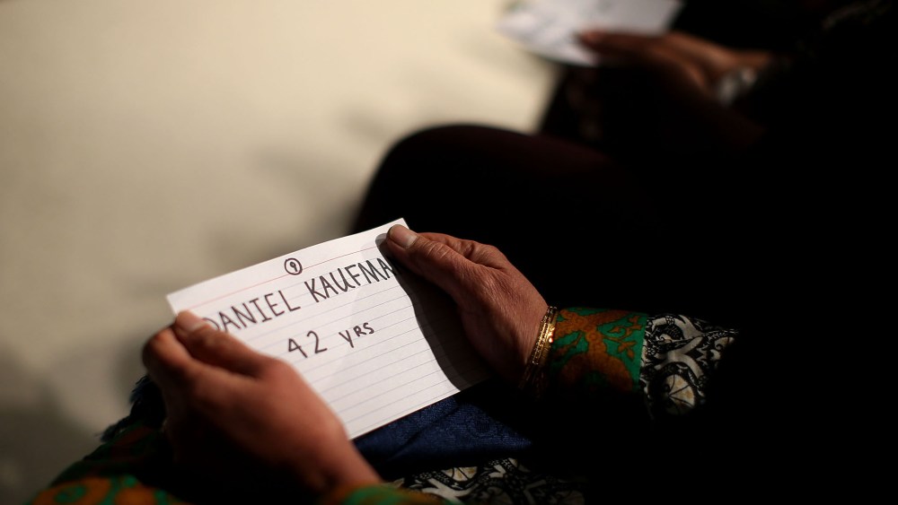 Mourners hold cards with the names of victims of the mass shooting in San Bernardino during a United We Stand vigil at Granada Hills Charter High School on Dec. 5, 2015 in Granada Hills, Calif. (Photo by Justin Sullivan/Getty)