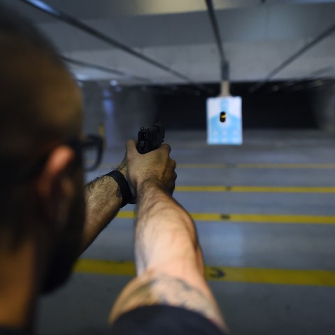 A man fires a handgun at a shooting range in New Jersey on Dec. 9, 2015. (Photo by Jewel Samad/AFP/Getty)