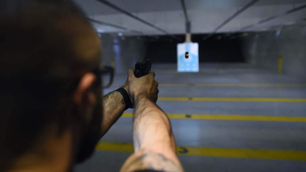 A man fires a handgun at a shooting range in New Jersey on Dec. 9, 2015. (Photo by Jewel Samad/AFP/Getty)
