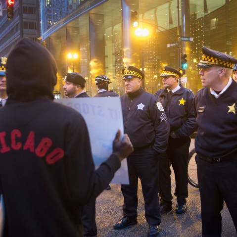 A demonstrator confronts police during a march through downtown on Dec. 12, 2015 in Chicago, Ill. (Photo by Scott Olson/Getty)